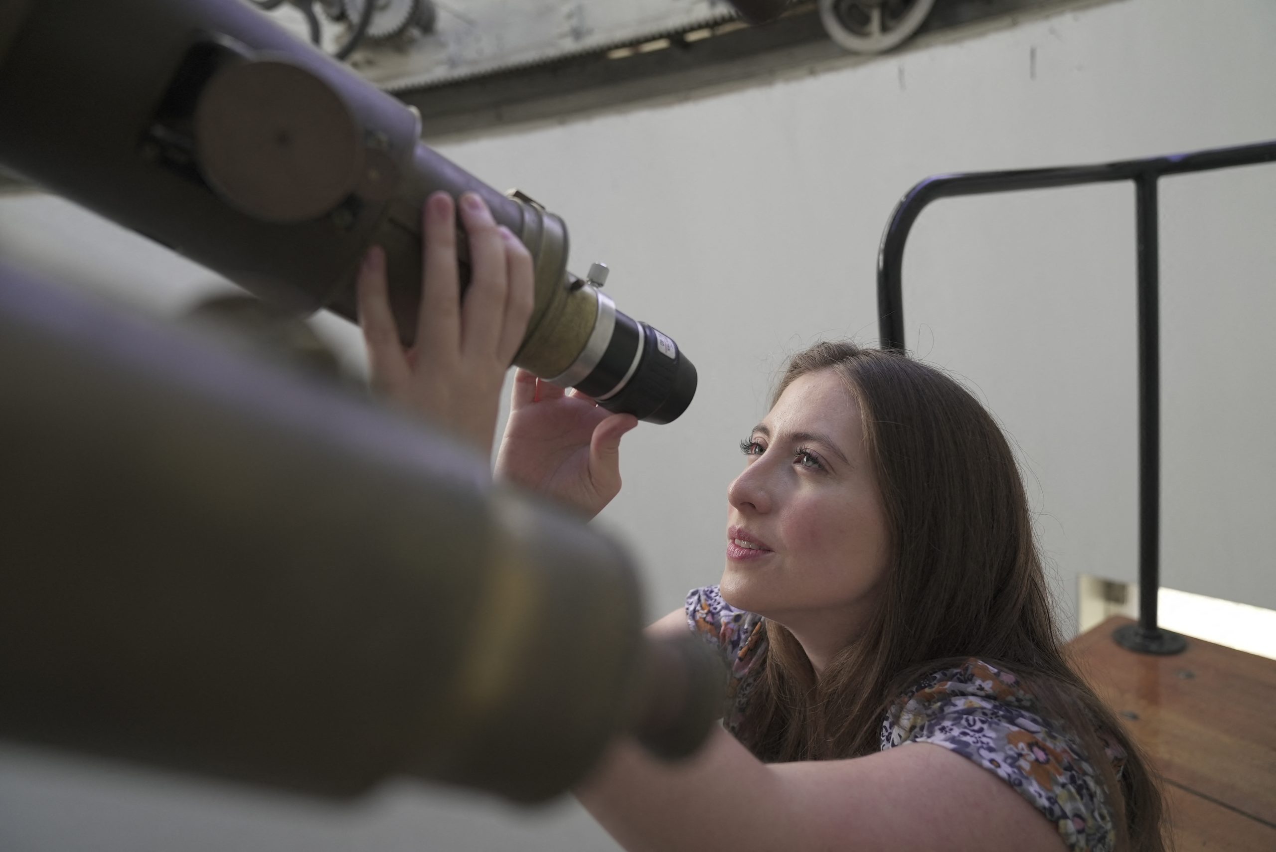Chilean astronomer Teresa Paneque, 26, looks through a telescope at the National Astronomical Observatory of Chile in Santiago on November 16, 2023. Panaque is one of Chile's youngest astronomers and science communicators, encouraging girls to get involved in the study of the stars in South America's most advanced country in the field. (Photo by Pablo COZZAGLIO / AFP)